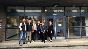 Bakerview Staff standing in front of the entrance to the school