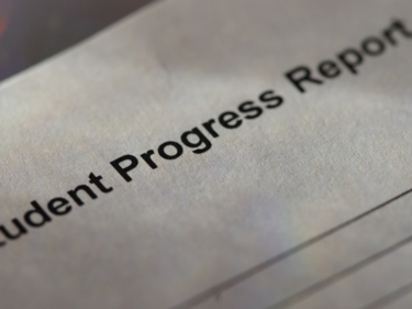 paper with printing says Student Progress Report