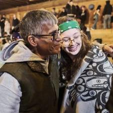 An Elder hugs one of the Indigenous Role Models